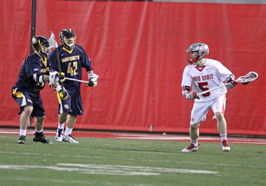 Junior midfielder Turner Evans (5) cradles the ball during a game against Marquette Feb. 22 at the Woody Hayes Athletic Center. OSU won, 11-7. Credit: Brett Amadon / Lantern reporter