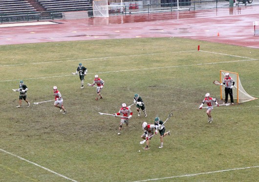 Members of the OSU lacrosse team rush to the ball during a game against Jacksonville March 29 at Jesse Owens Memorial Stadium. OSU won, 13-2. Credit: Dan Hope / Lantern photographer