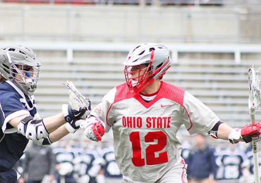 Junior midfielder David Planning (12) fights for position during a game against Penn State March 1 at Ohio Stadium. OSU lost, 11-8. Credit: Ryan Robey / For The Lantern