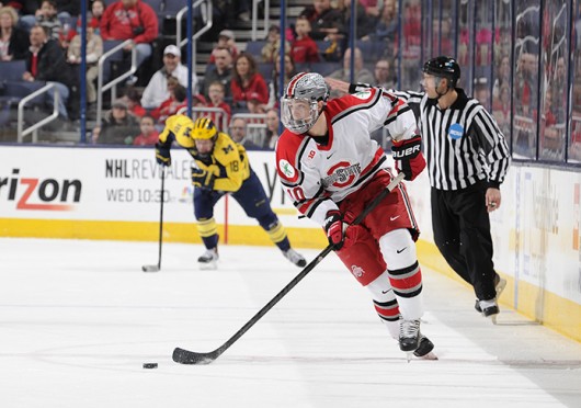 Junior forward Darik Angeli advances the puck during a game against Michigan March 2 at Nationwide Arena. OSU lost, 4-3. Credit: Ben Jackson / For The Lantern