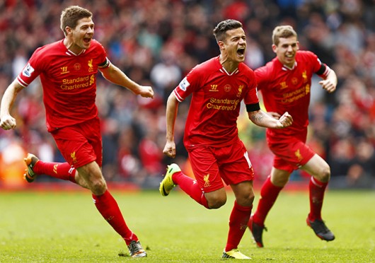 Liverpool midfielders Philippe Coutinho (center) and Steven Gerrard (left) and defender John Flanagan (right) celebrate scoring a goal during a match against Manchester City April 13 at Anfield. Liverpool won, 3-2. Courtesy of MCT