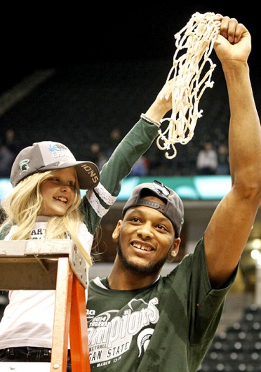 Michigan State senior center Adreian Payne (right) cuts down the nets with Lacey Holsworth after winning the Big Ten Tournament final against Michigan March 16 at Bankers Life Fieldhouse. Holsworth passed away from cancer April 9. Courtesy of MCT