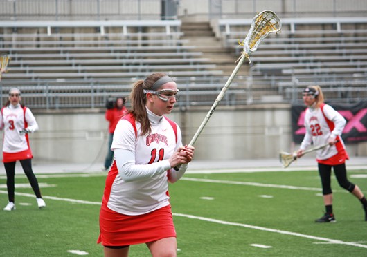 Then-sophomore attackman Katie Chase (11) warms up before a game against Notre Dame March 4, 2012, at Ohio Stadium. OSU lost, 16-7. Lantern file photo