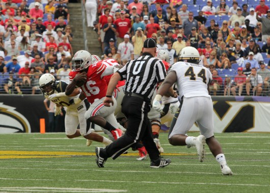 Ohio State redshirt-freshman quarterback J.T. Barrett takes off running in a game against Navy Aug. 30. OSU won 34-17. Credit: Mark Batke / photo editor