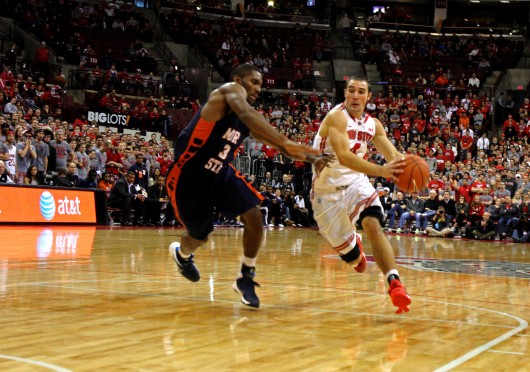 Then-senior guard Aaron Craft (4) drives to the basket during OSU's 89-50 win against Morgan State on Nov. 9, 2013. After not being selected in the 2014 NBA Draft, Craft signed as a free agent with the Golden State Warriors. Credit: Lantern file photo  