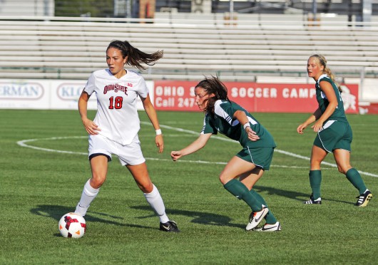 Then-sophomore forward Lindsay Agnew (18) dribbles the ball during a game against Eastern Michigan on Aug. 25, 2013, at Jesse Owens Memorial Stadium. OSU won, 2-1, in overtime. Credit: Lantern file photo