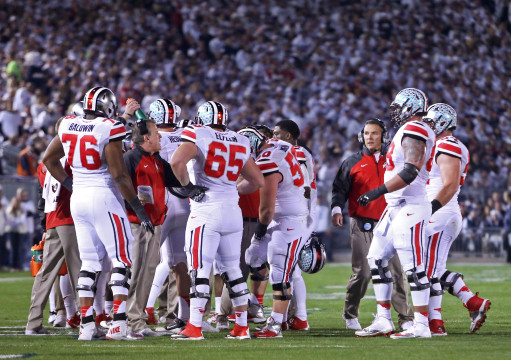 Members of the OSU offense huddle together to discuss a play during a game against Penn State Oct. 25 at Beaver Stadium in State College, Pa. OSU won 31-24 in double-overtime. Credit: Mark Batke / Photo editor