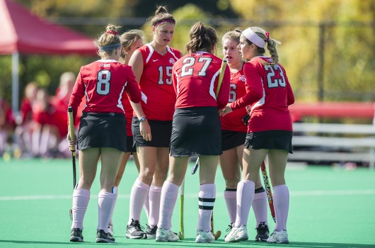 OSU field hockey players gather in a huddle during a game against Iowa on Oct. 19, 2014 at Buckeye Varsity Field. OSU lost, 4-2.  Credit: Lantern file photo