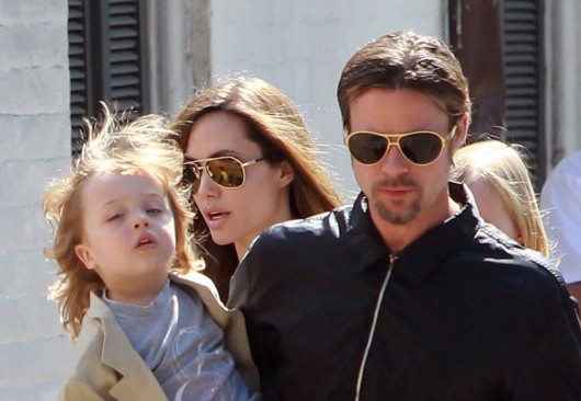 Brad Pitt (left), Angelina Jolie and their daughter Shiloh go for a walk in their neighborhood on March 20, 2011 in New Orleans. Credit: TNS