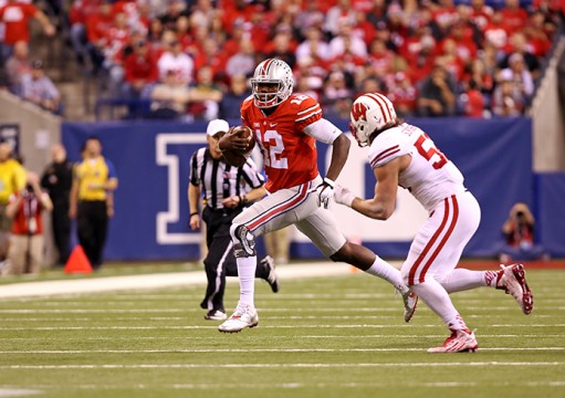 Redshirt-sophomore quarterback Cardale Jones (12) carries the ball during the Big Ten Championship Game against Wisconsin on Dec. 6 in Indianapolis. OSU won, 59-0. Credit: Mark Batke / Photo editor
