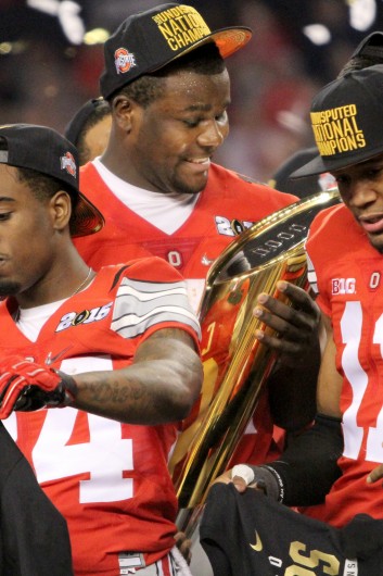 Redshirt-sophomore quarterback Cardale Jones holds the College Football Playoff National Championship trophy after OSU's 42-20 win against Oregon in the title game on Jan. 12 in Arlington, Texas.  Credit: Mark Batke / Photo editor