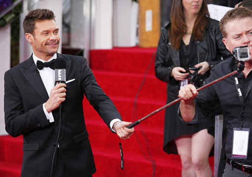 Ryan Seacrest gets his selfie video camera adjusted on the red carpet at the 72nd Annual Golden Globe Awards show at the Beverly Hilton Hotel in Beverly Hills, Calif., on Sunday, Jan. 11, 2015. Credit: Courtesy of TNS.