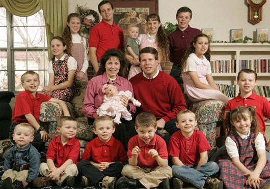 Jim Bob, 40, center right, and Michelle Duggar, 39, center left, pose for family portrait with their 16 biological children, ten boys, and six girls, at their family home in Springdale, Arkansas, December 14, 2005.  Credit: Courtesy of TNS