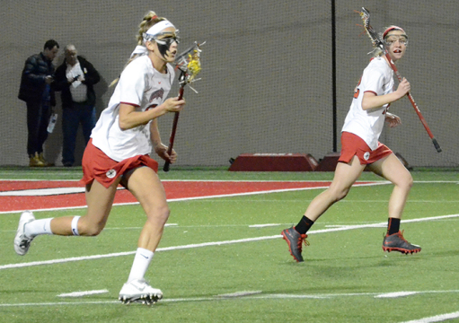 Senior defender Taylor Donahue (left) streaks up the field during a game against Niagra on March 1 in Columbus. OSU won, 15-2. Credit: Leah Alexander / Lantern photographer