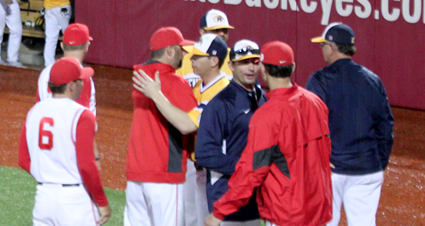 OSU and Kent State coaches and players shake hands after the cancellation of an April 8 game at Bill Davis Stadium. The game was cancelled after the 4th inning due to weather.  Credit: Zoe Chrysochoos / Lantern photographer
