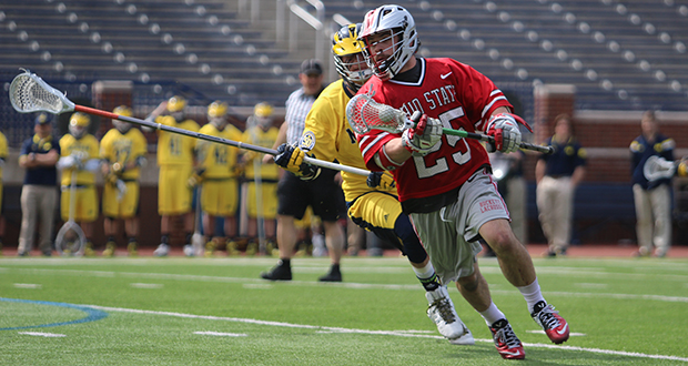 Senior midfielder Christopher May (25) carries the ball during a game against Michigan on April 12 in Ann Arbor, Mich. OSU won, 13-8. Credit: Molly Tavoletti / Lantern reporter