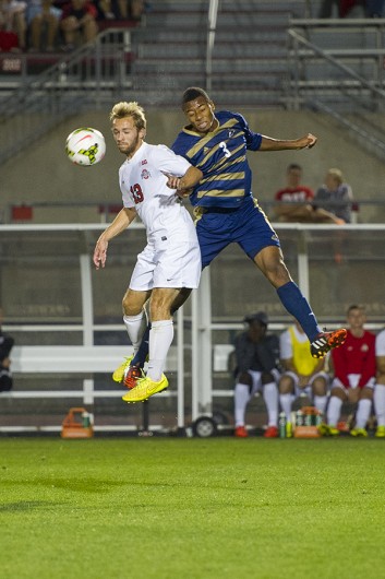OSU sophomore forward Christian Soldat (13) goes up to head a ball during a game against Akron on Sept. 24 at Jesse Owens Memorial Stadium. OSU lost, 3-1. Credit: Lantern File Photo