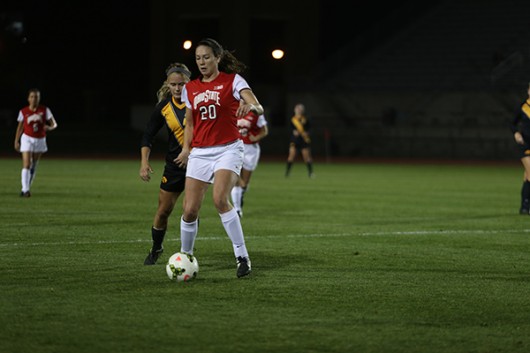 Then sophomore forward Lindsay Agnew (20) maintains possession during a match Oct. 24, 2014 against Iowa at Jesse Owens Memorial Stadium. Credit: Lantern File Photo 
