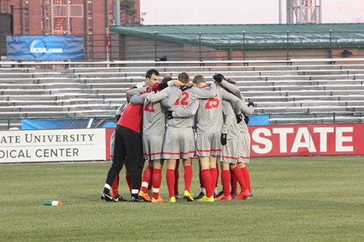 OSU mens soccer players gather in a huddle during a game. Credit: Lantern File Photo