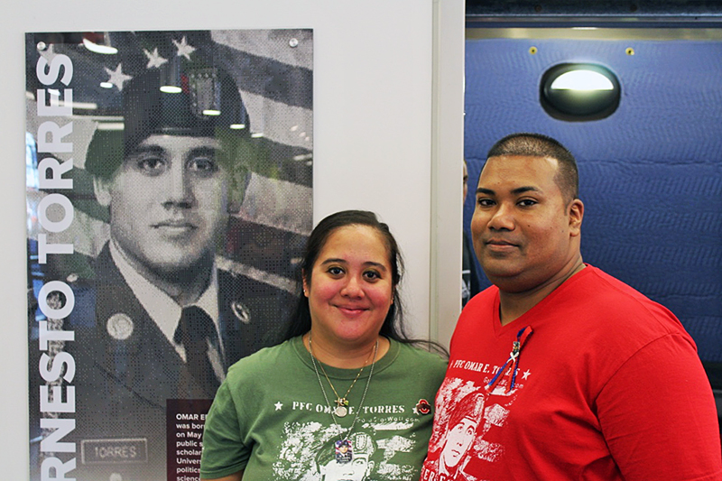 Oralia, Omar's sister and Sam, Oralia's husband pose in front of a photo of Omar Ernesto Torres in Torres House on August 22 in Columbus, Ohio. Photo Credit: Michael Huson / Campus Editor 