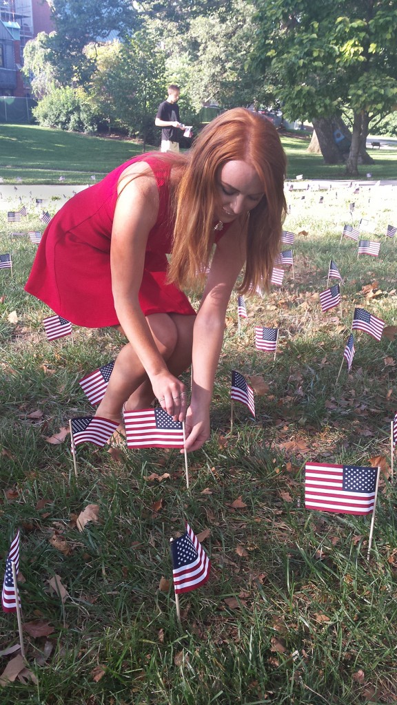 Morgan Shafley, a third-year in animal sciences, places an American flag on the South Oval during Friday's 9-11 memorial. Photo by Joely Friedman