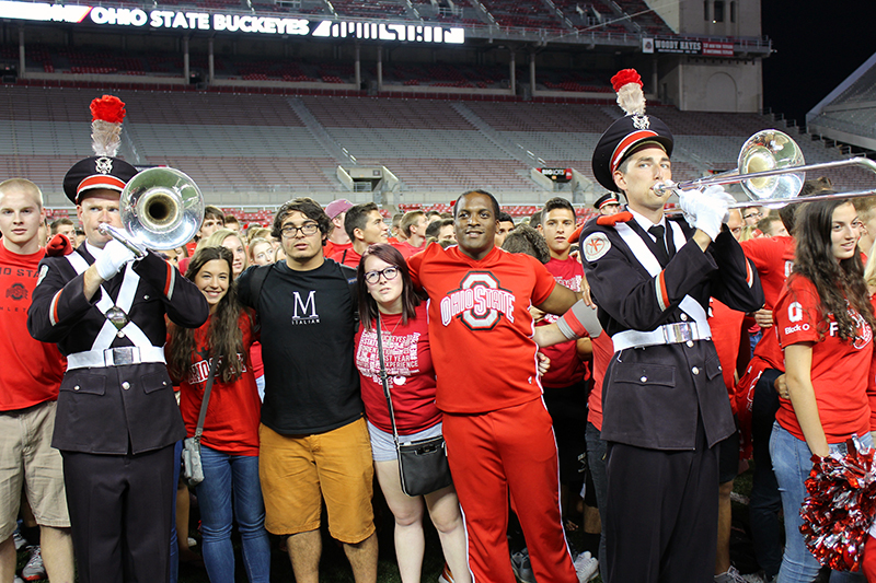 Students stand with members of the OSU marching band and OSU cheerleaders during the 2015 Buckeye Kick-Off event held at Ohio Stadium on August 27. Credit: Michael Huson / Campus Editor