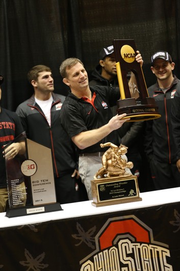Coach Tom Ryan lifts the the Buckeyes’ national championship trophy as fans applaud during a national championship celebration for the OSU wrestling team on March 28 at St. John Arena. Credit: Lantern File Photo