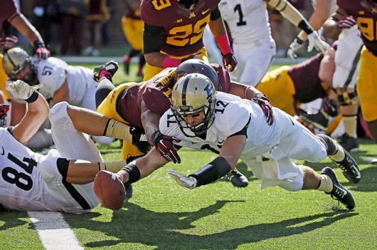 Purdue's quarterback Austin Appleby (12) jumped toward the goal line for a touchdown in the third quarter as the Minnesota Gophers took on the Purdue Boilermakers on Oct. 18, 2014 at TCF Bank Stadium in Minneapolis. Credit: Courtesy of TNS