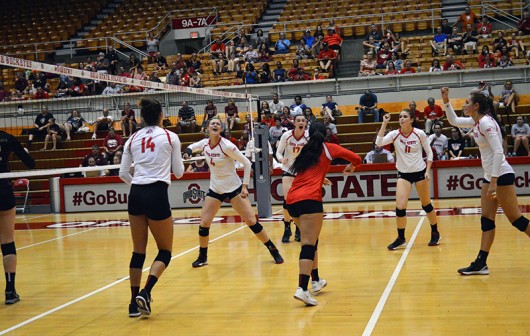 Members of OSU womens volleyball team celebrate after a play during a game against Florida State on September 6 at St. John’s Arena. Credit: Ashley Roudebush / For The Lantern
