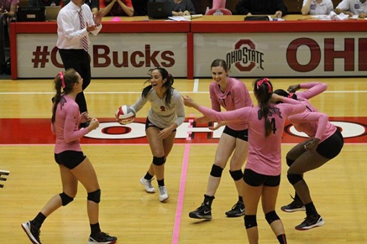 Members of the OSU women's volleyball team celebrate during a game against Iowa on Oct. 2 at St. John Arena. OSU won 3-2. Credit: Giustino Bovenzi / Lantern Photographer