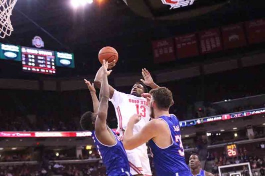 OSU freshman JaQuan Lyle (13) takes a shot over two UT Arlington players during a game on Nov. 20 at the Schottenstein Center in Columbus, Ohio. OSU lost 73-68. Credit: Hanna Roth | Lantern Photographer