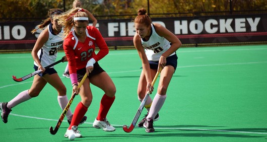 OSU sophomore forward/midfield Maddy Humphrey (23) protects the ball from California sophomore midfield/back Mara Gutierrez (24) and redshirt junior back Michaela Swensen (18) during a field hockey game on Oct. 25, 2015, at Buckeye Varsity Field. Credit: Lantern File Photo