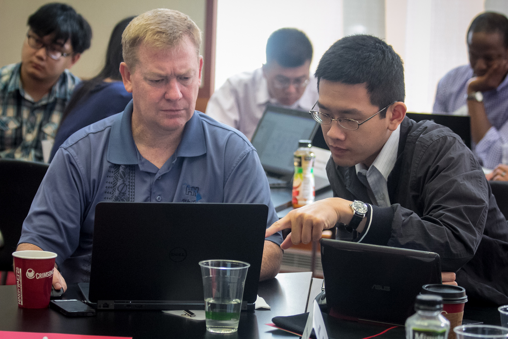 John Bair (left), a mentor of the engineering team, and Bert Liu, student lab member of the engineering team, working at the I-Corps@Ohio Program. Photo courtesy of I-Corps@Ohio. 