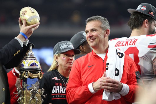 OSU coach Urban Meyer flashes a grin while on the podium celebrating the Buckeyes' 44-28 victory over Notre in the Fiesta Bowl on Jan. 1. Credit: Samantha Hollingshead | Photo Editor 