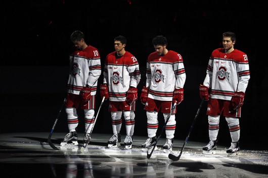OSU hockey players stand in the spotlight during introductions for a game against Michigan on Jan. 15 at the Schottenstein Center. Credit: Kevin Stankiewicz | Asst. Sports Editor