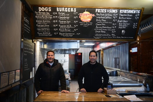 Carmen Gio (left) and Nick Gio (right) pose for a photograph behind the counter of Rippers Roadstand. Credit: Kevin Stankiewicz | Assistant Sports Editor