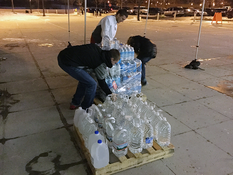 A crew works to secure donations for placement in the truck at the end of night one of the Flint water drive. Credit: Elizabeth Suarez | Lantern Reporter