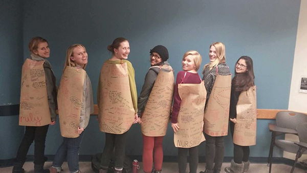 Members of the Girls Circle Project donned capes with motivational quotes written on them as part of a Women's Circle curriculum activity. Credit: Courtesy of Molly Duerre