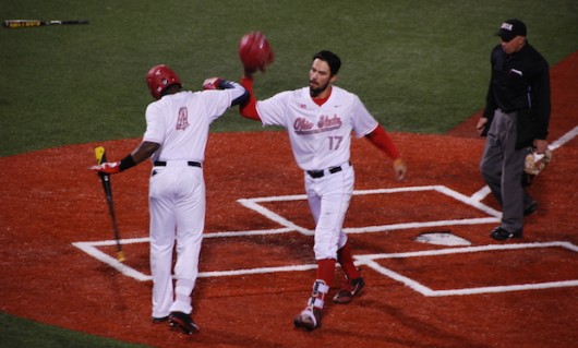 OSU junior left fielder Ronnie Dawson (4) and redshirt junior right fielder Jacob Bosiokovic (17) celebrate at the plate during a 9-8 win over Toledo on March 30 at Bill Davis Stadium. Credit: Edward Sutelan | For The Lantern