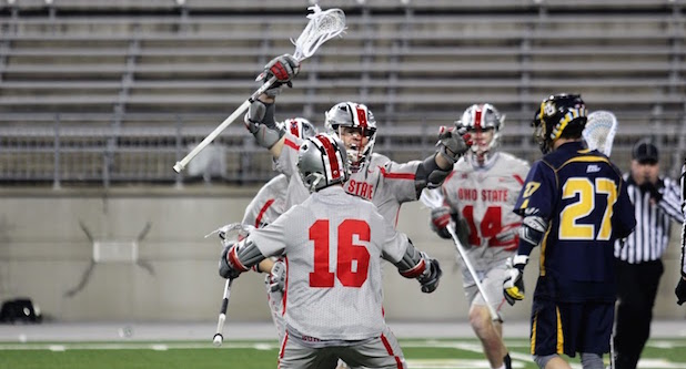 OSU senior attacker Ryan Hunter (16) celebrates with teammates after a goal during a game against Marquette on March 4 at Ohio Stadium. OSU won 12-8. Credit: Jenna Leinasars | Multimedia Editor