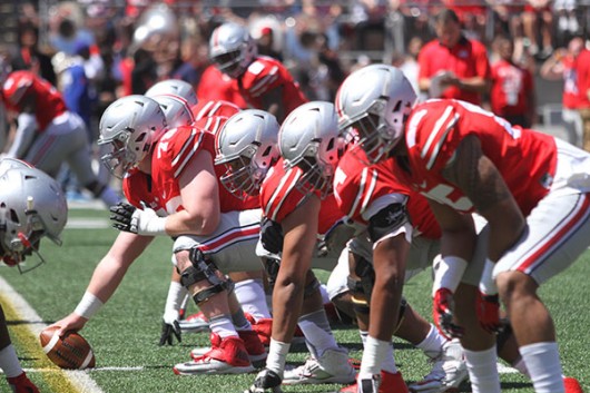 OSU’s scarlet offensive line gets set during the spring game on April 16 at Ohio Stadium. Credit: Lantern File Photo