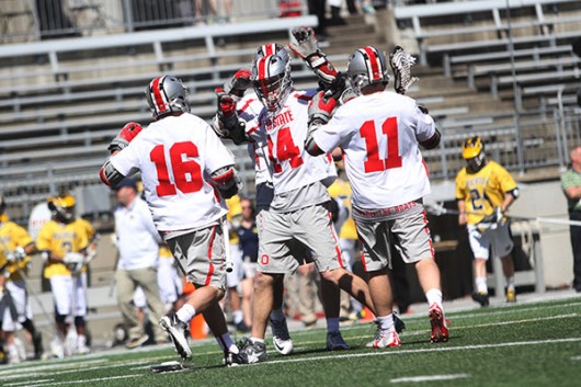 OSU players celebrate after a goal during a game against Michigan on April 16 at Ohio Stadium. Credit: Samantha Hollingshead | Photo Editor 