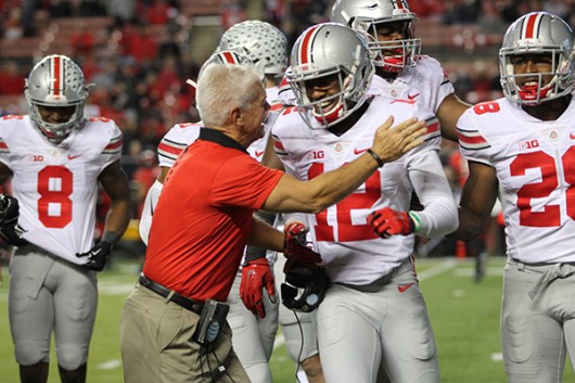 OSU cornerback coach Kerry Coombs and then-freshman cornerback Denzel Ward (12) celebrate after a tackle by Ward during a game against Rutgers on Oct. 24 at High Point Solutions Stadium in Piscataway Township, NJ . Credit: Lantern file photo 