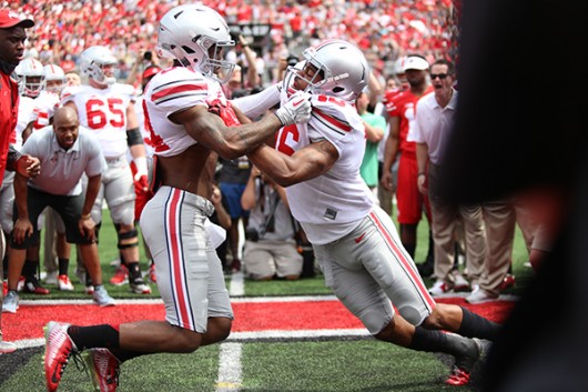 OSU then-redshirt junior Corey Smith (84) and then-sophomore Cam Burrows (16) face off during the 2015 Spring Game on April 18 at Ohio Stadium. Credit: Lantern File Photo 