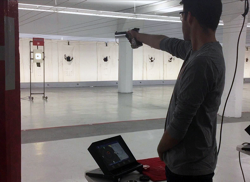 OSU junior Seth Bearjar lines up a shot at the team’s shooting range in Converse Hall. Credit: Courtesy of OSU