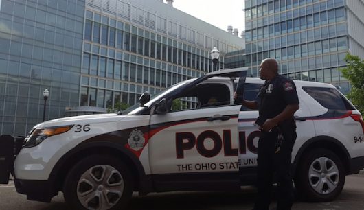 An Ohio State University police officer blocks off the road during an incident at the Chemical and Biomolecular Engineering and Chemistry building. Credit: Michael Huson | Managing Editor for Content