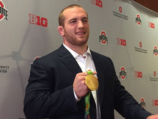 OSU junior Kyle Snyder shows off his gold medal at the Welcome Back event for OSU Olympians. Credit: Ashley Nelson | Sports Director