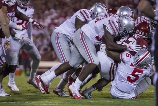 Members of the Ohio State defense bring down Oklahoma running back Samaje Perine during a game on Sept. 17, 2016. Credit: Alexa Mavrogianis | Photo Editor