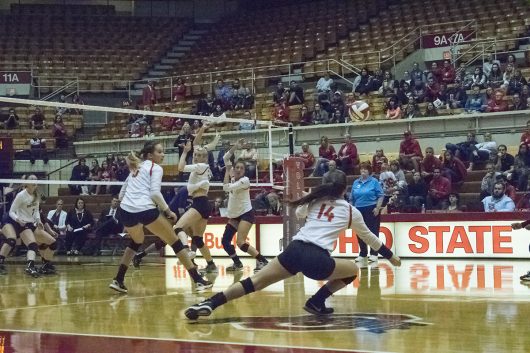 OSU freshman defensive specialist Camry Halm (14) dives for a ball during a game against Northwestern University on Sept. 28 at St. John Arena in Columbus, Ohio. OSU won 3-0. Credit: Ross Tamburro | Lantern Photographer