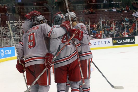 Members of Ohio State's men's ice hockey team celebrate a goal by freshman forward Tanner Laczynski (9) in the third period of the Buckeye's game against Bowling Green on Oct. 22. The Buckeyes won 6-1. Credit: Breanna Crye | For The Lantern 